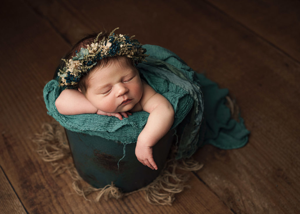 newborn bucket posing with flowers maddy rogers