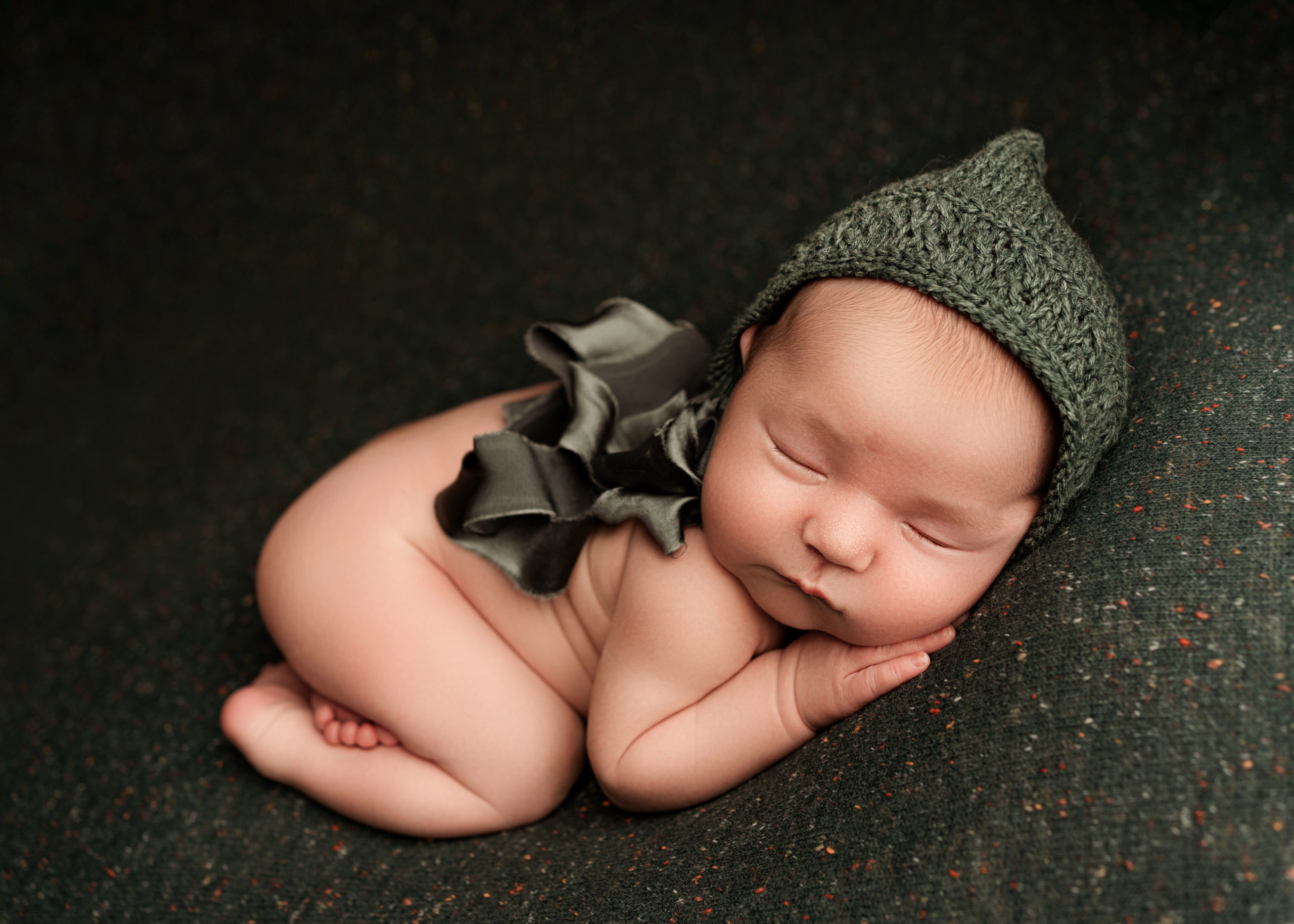 baby girl on green with silk bonnet